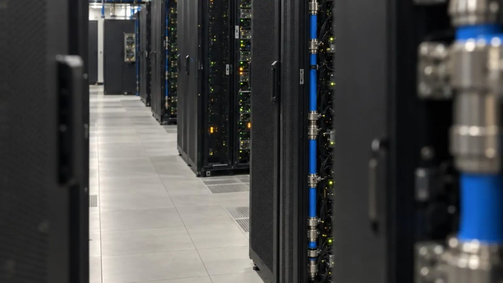 Rows of liquid-cooled computing systems in an AI facility